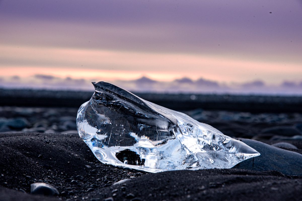 Glacier ice on the black sand at dawn